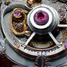 Close-up of intricate watch gears and escapement, representing movement quality